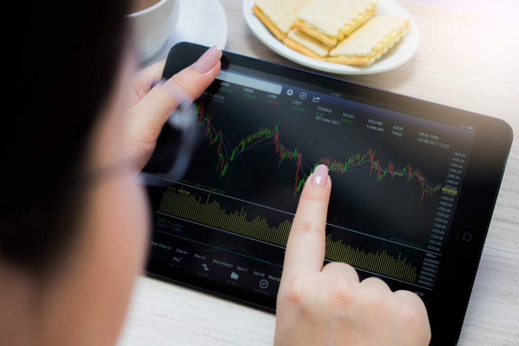 Mão tocando o gráfico de sistema de gestão financeira em um tablet